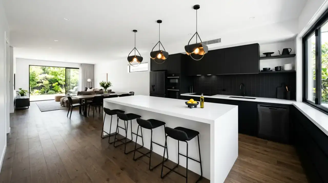 Black pantry wall kitchen. Architectural dark storage wall adding depth to a bright modern kitchen.